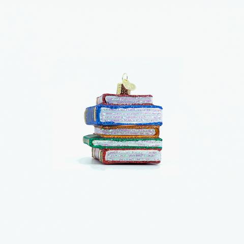 Stack of books ornament turned slightly to show blue and green covers and glittered page edges