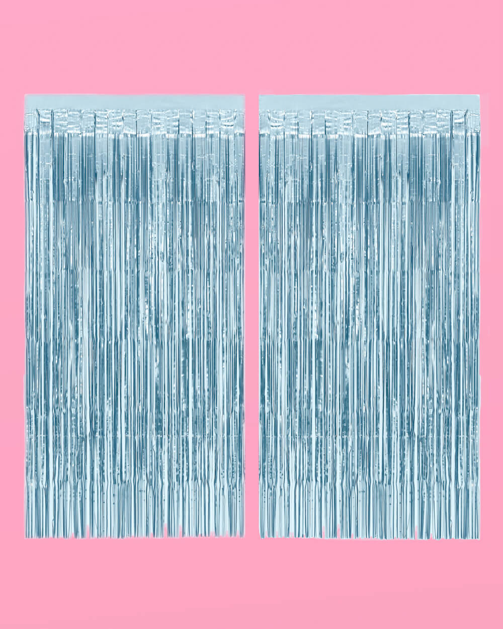 Two light blue foil fringe curtain panels hung side by side on a pink background