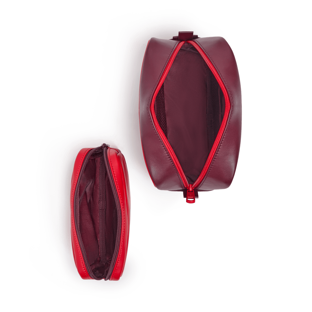 Overhead view of both pouches unzipped, showing red interior lining