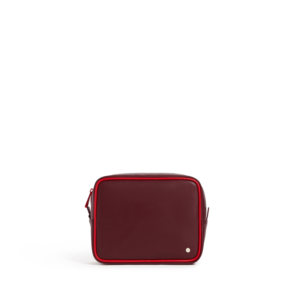 Burgundy travel pouch with the red pouch nested inside, front view with red zipper trim