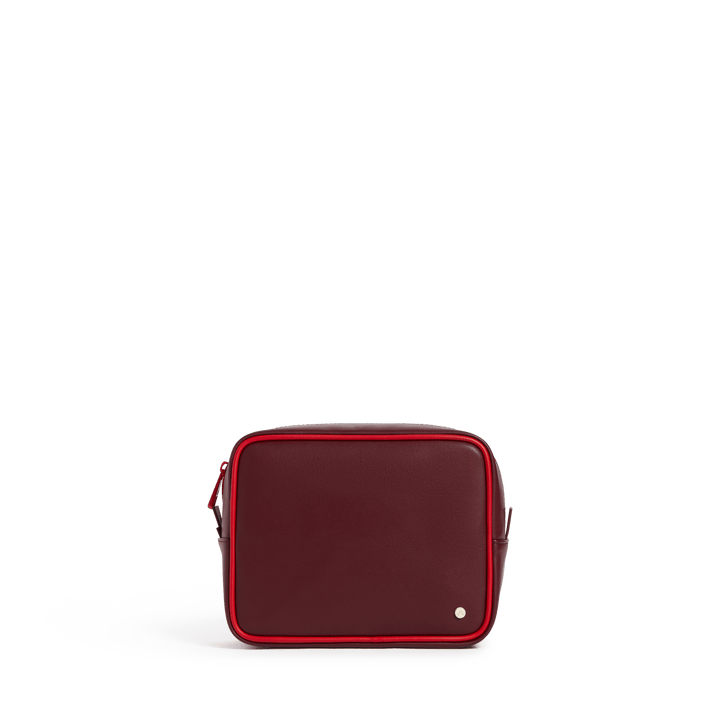 Burgundy travel pouch with the red pouch nested inside, front view with red zipper trim