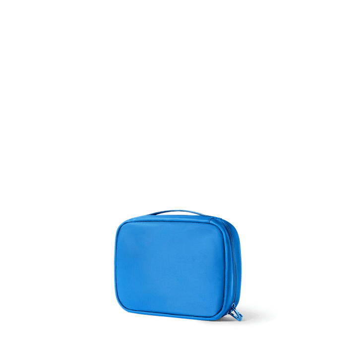 Blue Bensen toiletry bag from the three-quarter back angle, showing its zip-around shape
