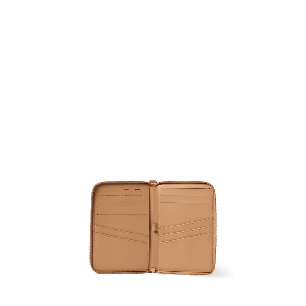 Sand passport holder opened flat, showing passport pockets and card slots