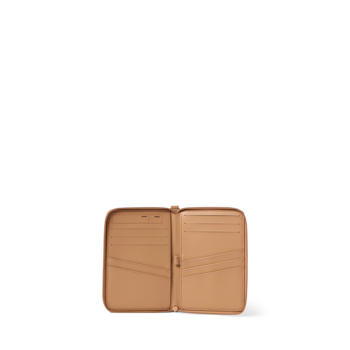 Sand passport holder opened flat, showing passport pockets and card slots