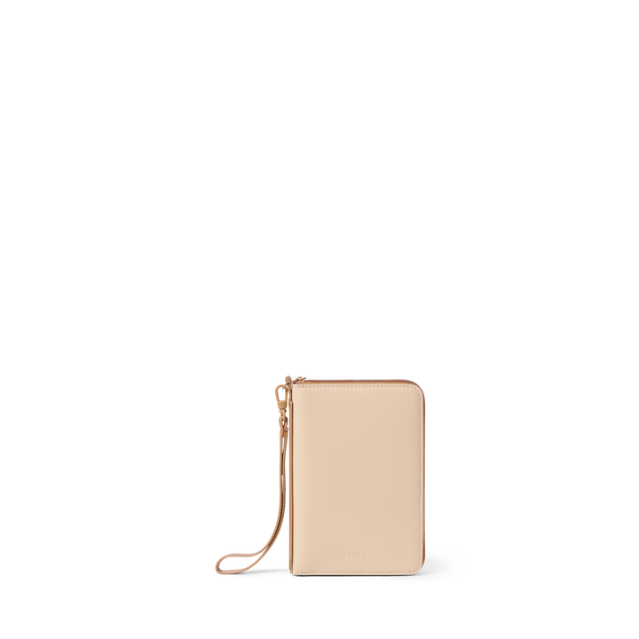 STATE family passport holder in sand vegan leather, closed front view with wristlet strap