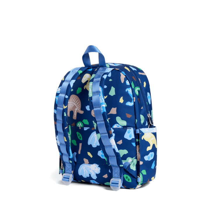 Back of the navy Dino Fossils Kane backpack with periwinkle padded straps