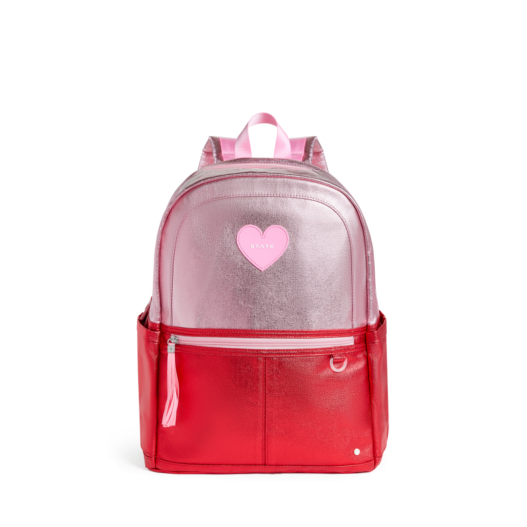 Metallic pink and cherry red colorblock STATE backpack with a pink heart patch, front view