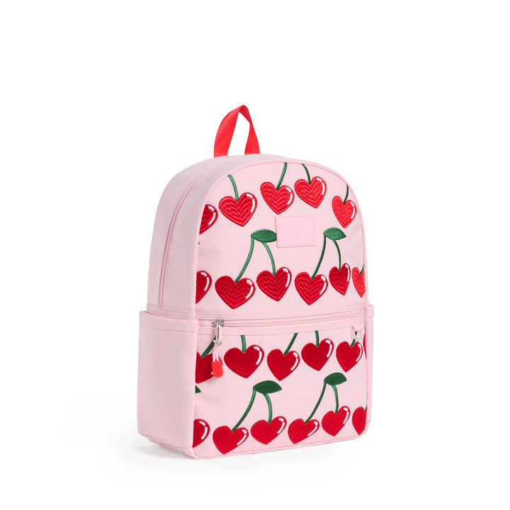 Pink Cherry Kane backpack at a three-quarter angle showing the side pocket