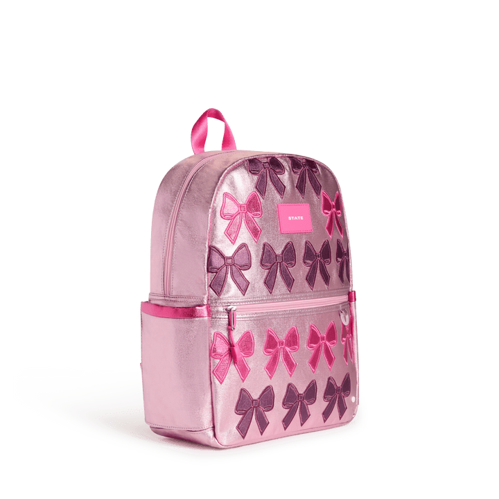 Pink Patchwork Bows Kane backpack at a three-quarter angle showing the side pocket