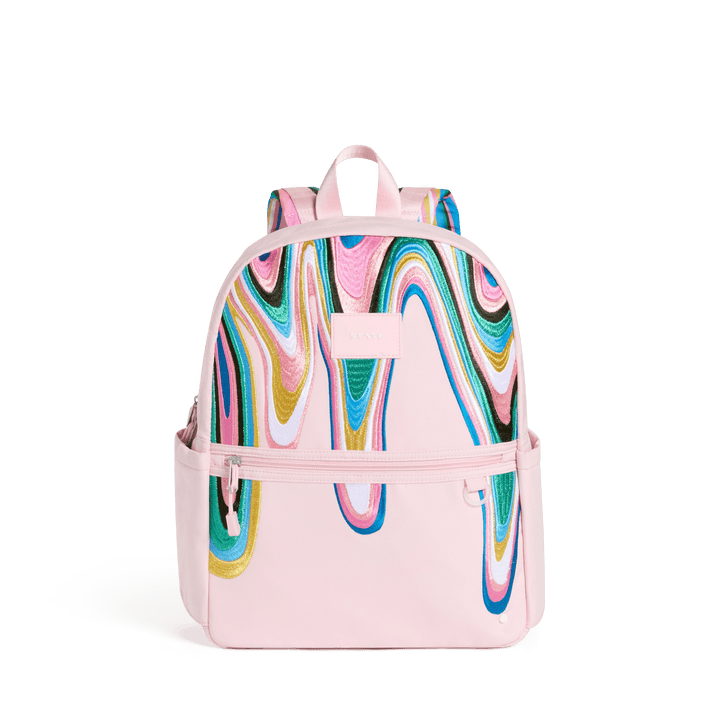 STATE Kane kids backpack in blush pink with a swirling navy, teal, green, and gold paint wave, front view
