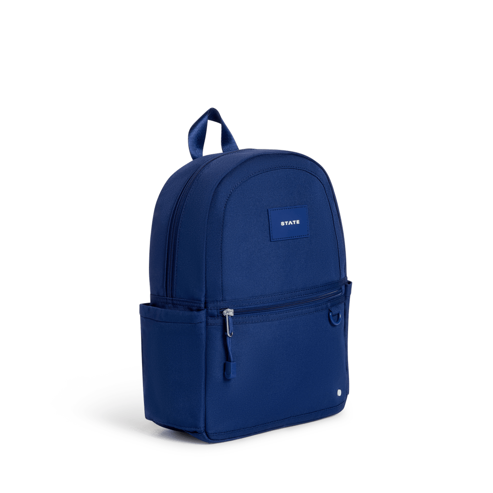 Navy mini backpack at a three-quarter angle showing the side water bottle pocket
