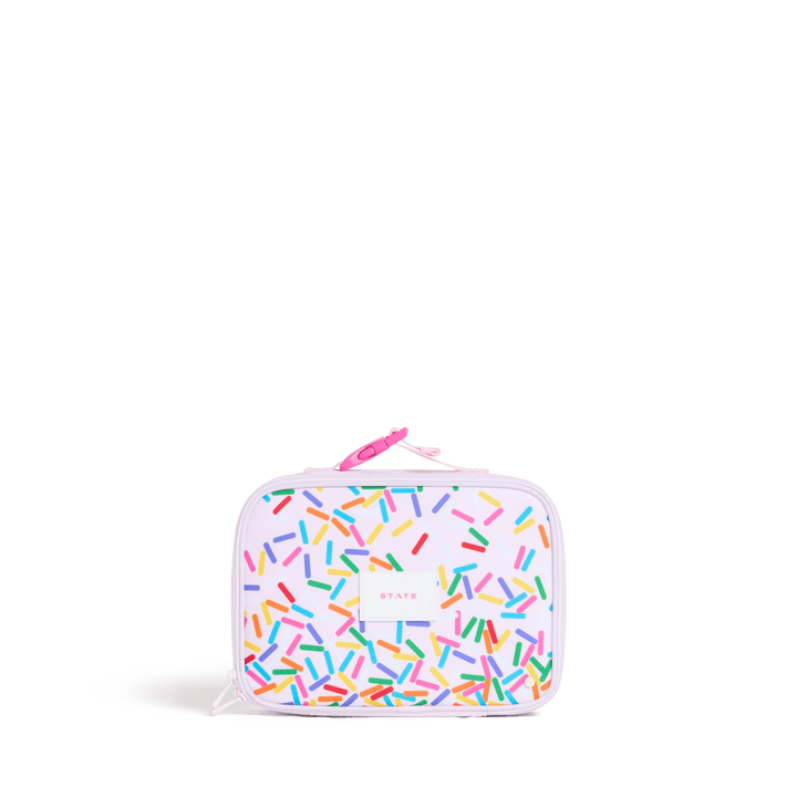 STATE Rodgers kids lunch box covered in rainbow sprinkles on pale lilac with pink buckle