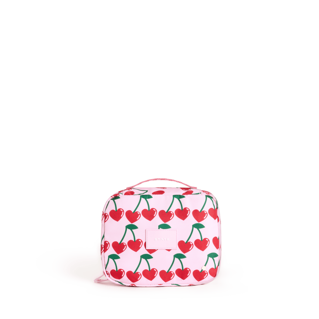 STATE Bensen kids toiletry bag in Cherry print, front view of red cherries on blush pink
