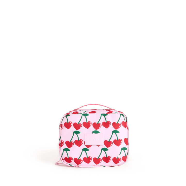 STATE Bensen kids toiletry bag in Cherry print, front view of red cherries on blush pink