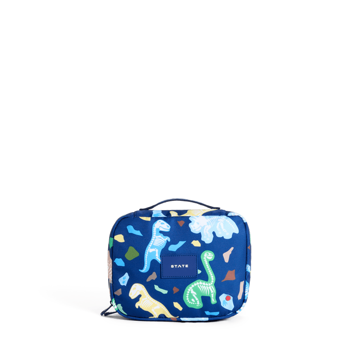 STATE Bensen kids toiletry bag in Dino Fossils print, front view of pastel dinosaurs on navy