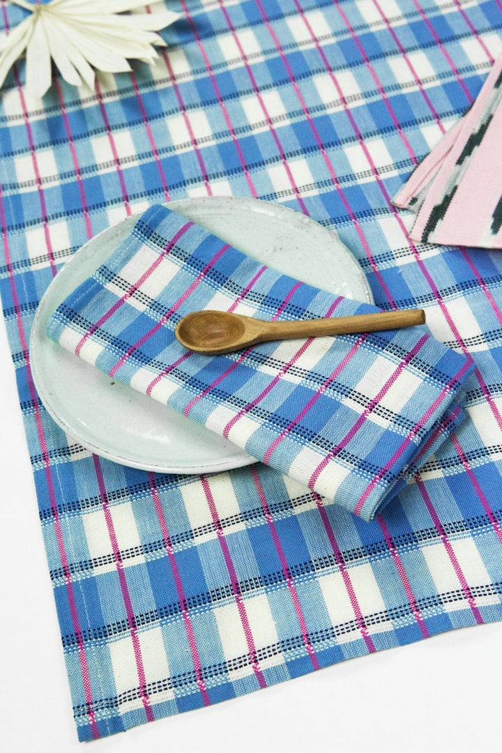 Detail of blue and white gingham table runner showing navy and hot pink stripes