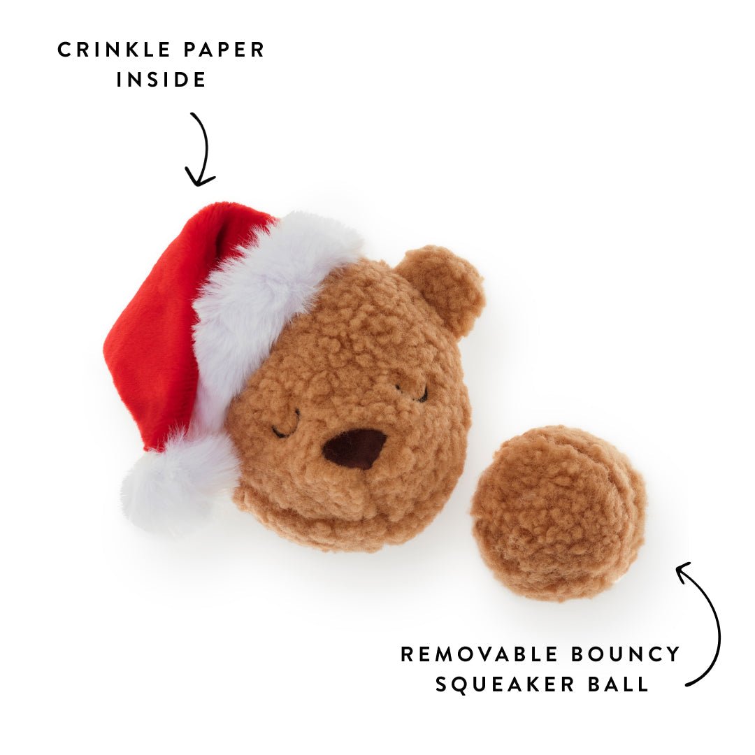 Teddy toy beside its removable tan sherpa squeaker ball, crinkle in the hat labeled