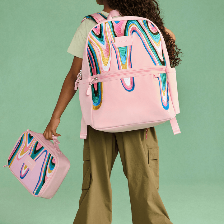 Child wearing the Paint Wave Kane Backpack and carrying the matching Rodgers lunch box