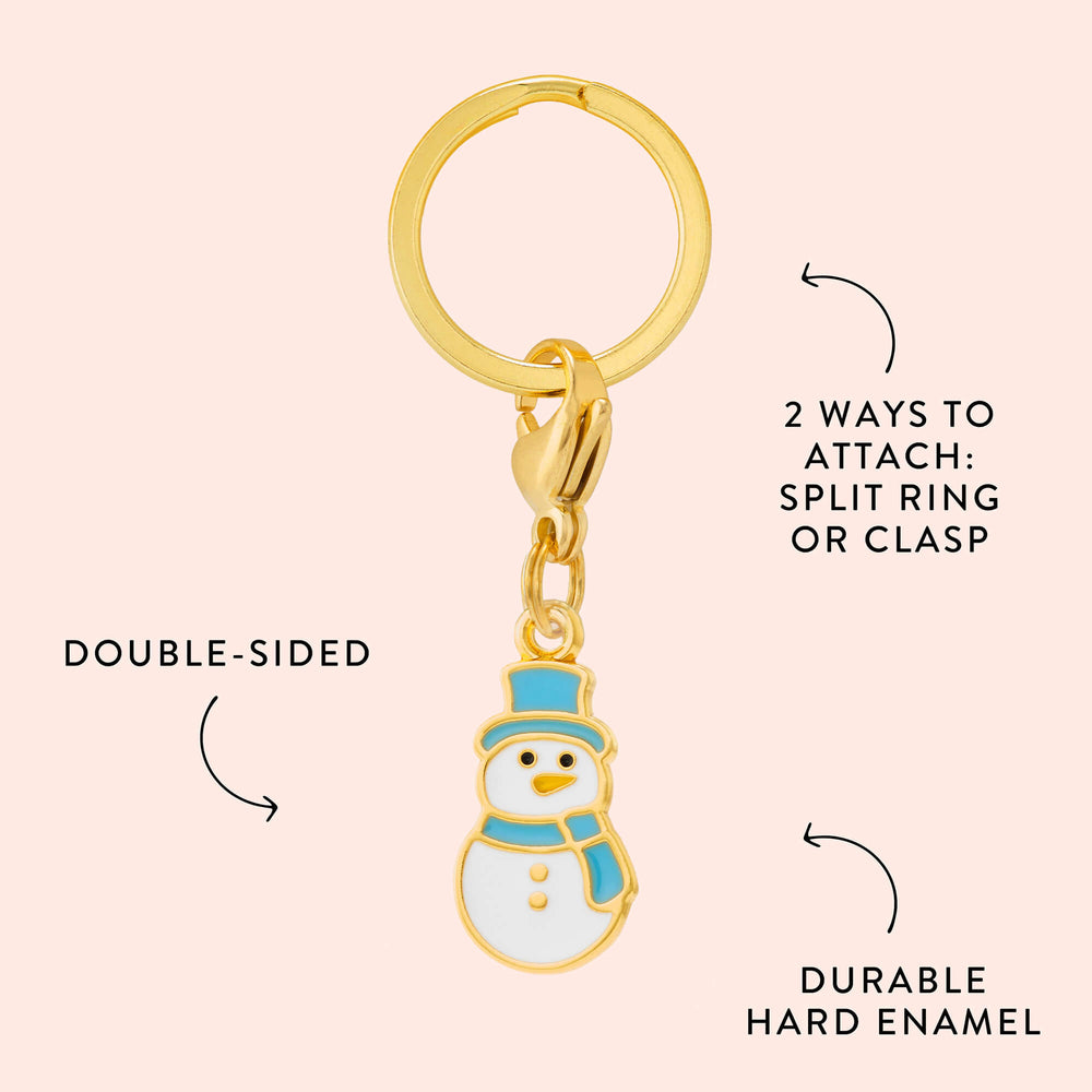 Snowman charm callout on blush noting double-sided design, hard enamel, and split ring or clasp