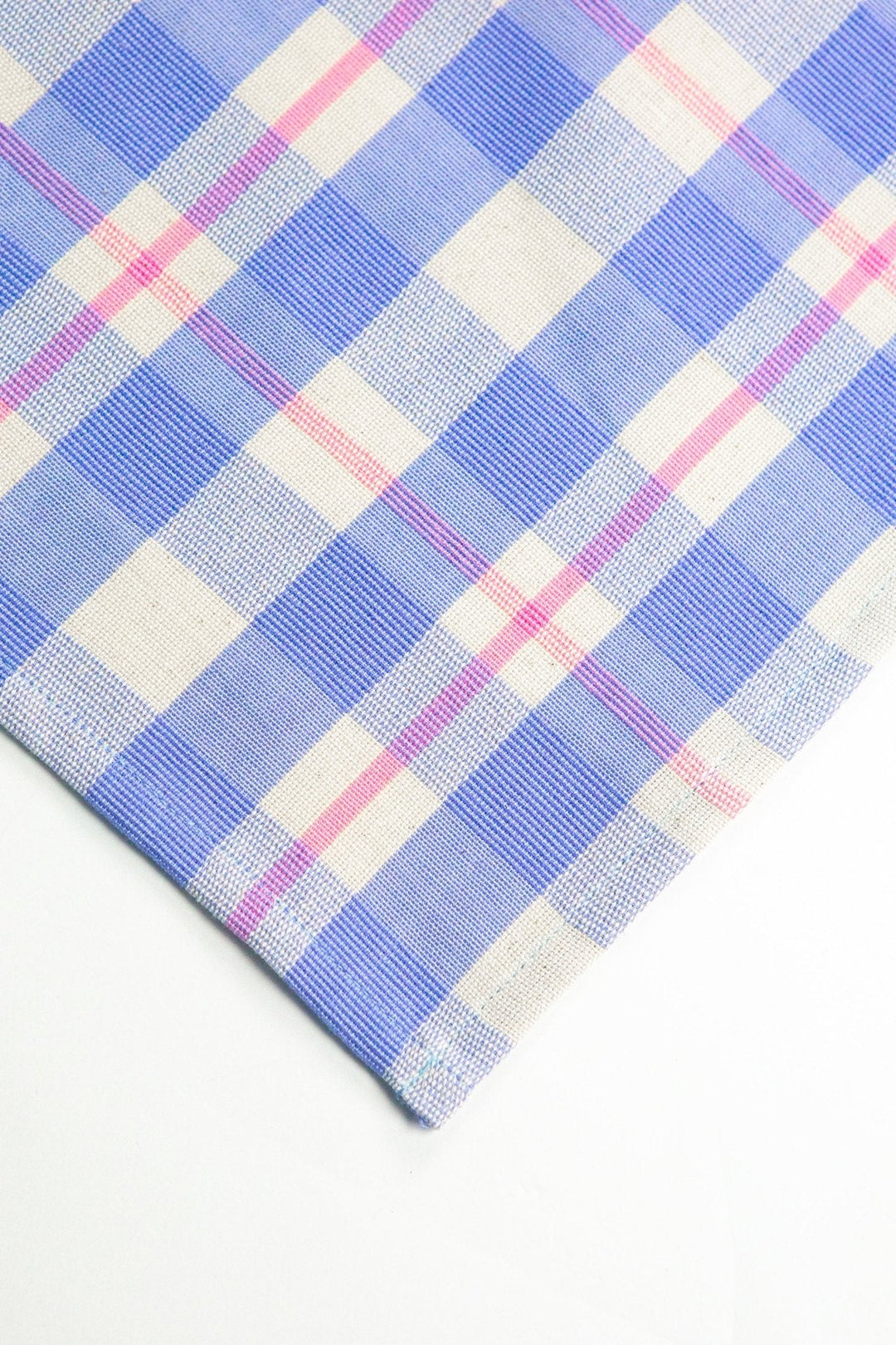 Close-up of periwinkle and pink handwoven cotton plaid weave