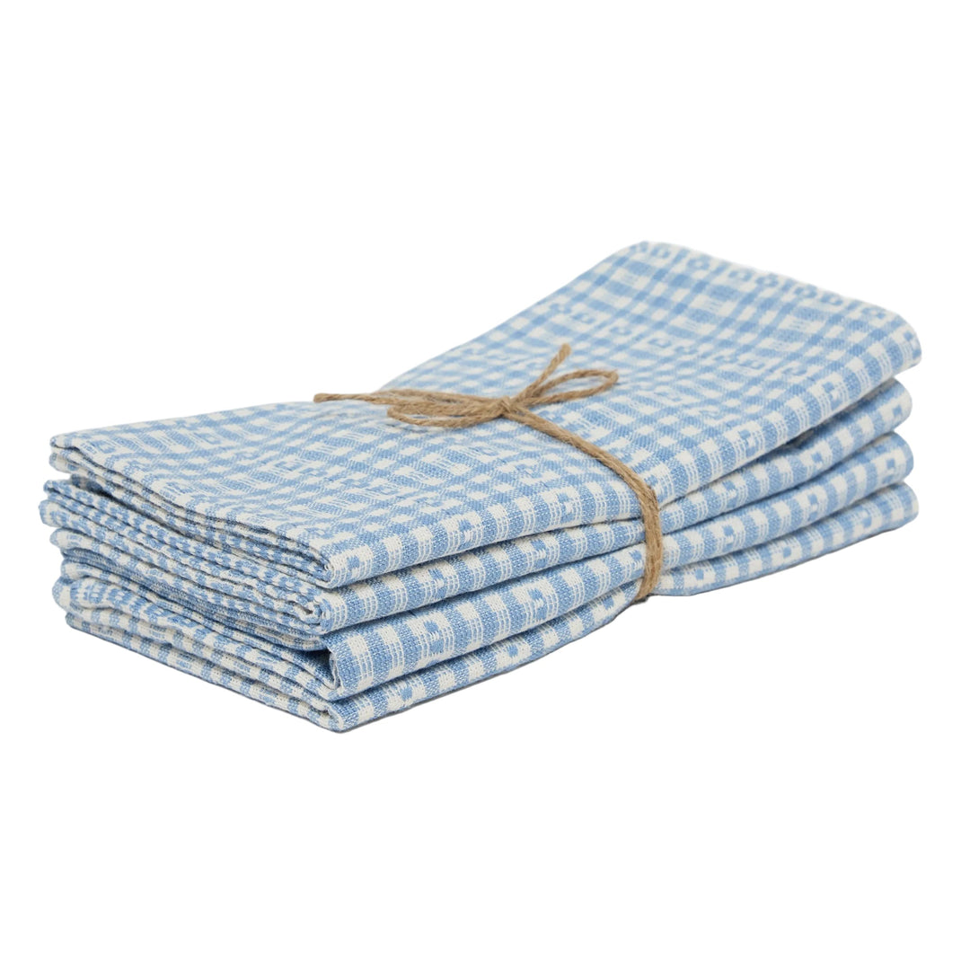Stack of blue checkered napkins tied with twine on a white background