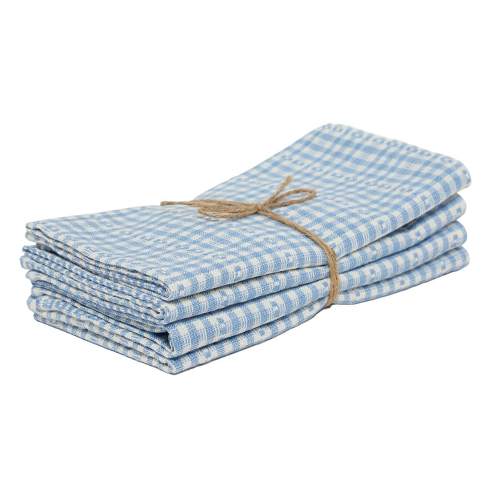 Stack of blue checkered napkins tied with twine on a white background