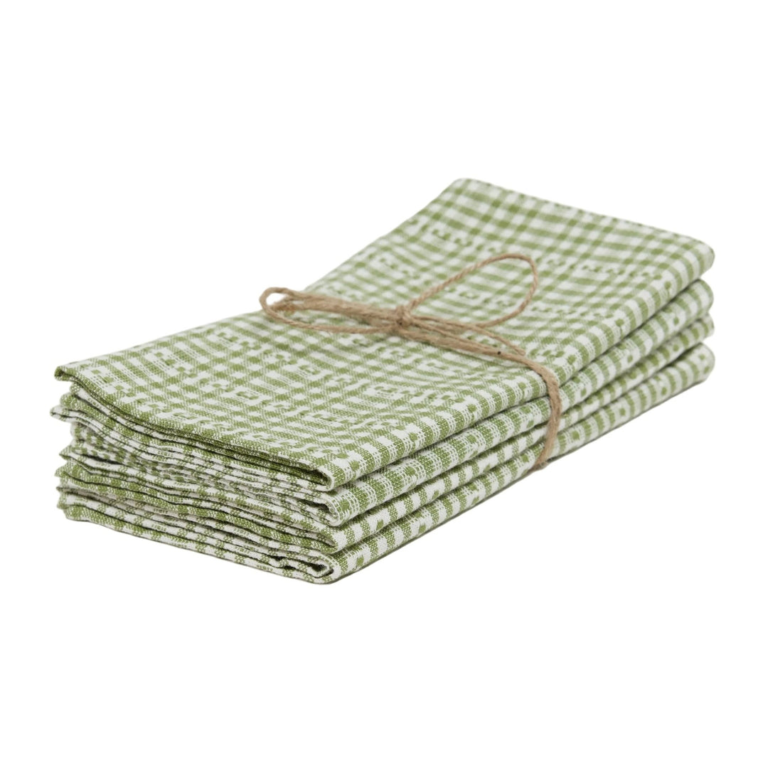 Stack of green checkered towels tied with twine on a white background