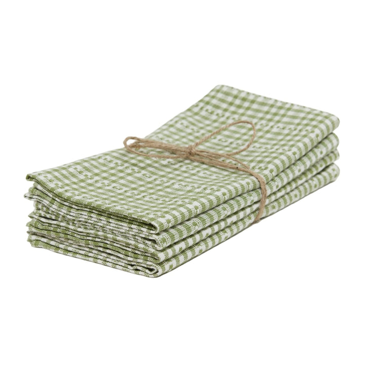 Stack of green checkered towels tied with twine on a white background