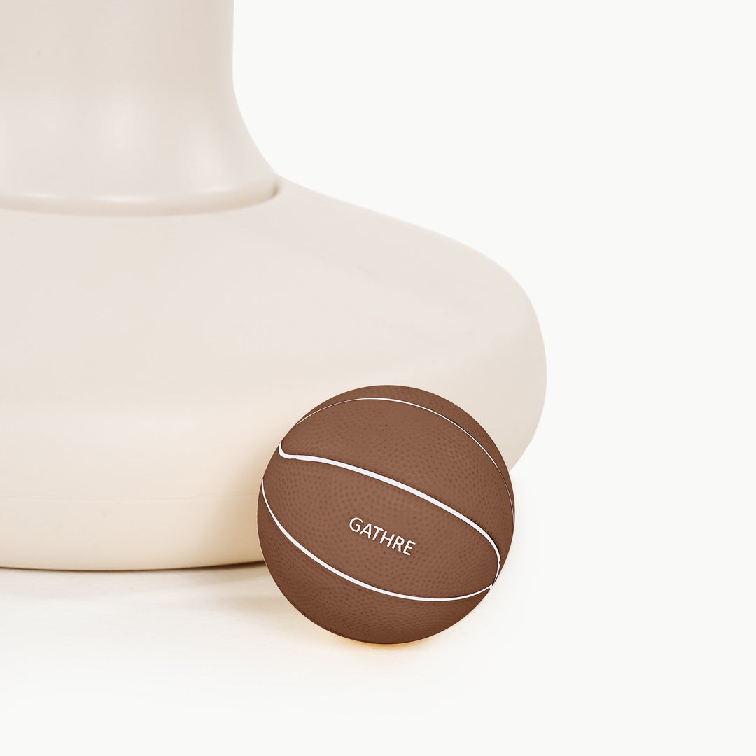 Close-up of the ivory hoop's rounded weighted base with the Gathre logo basketball