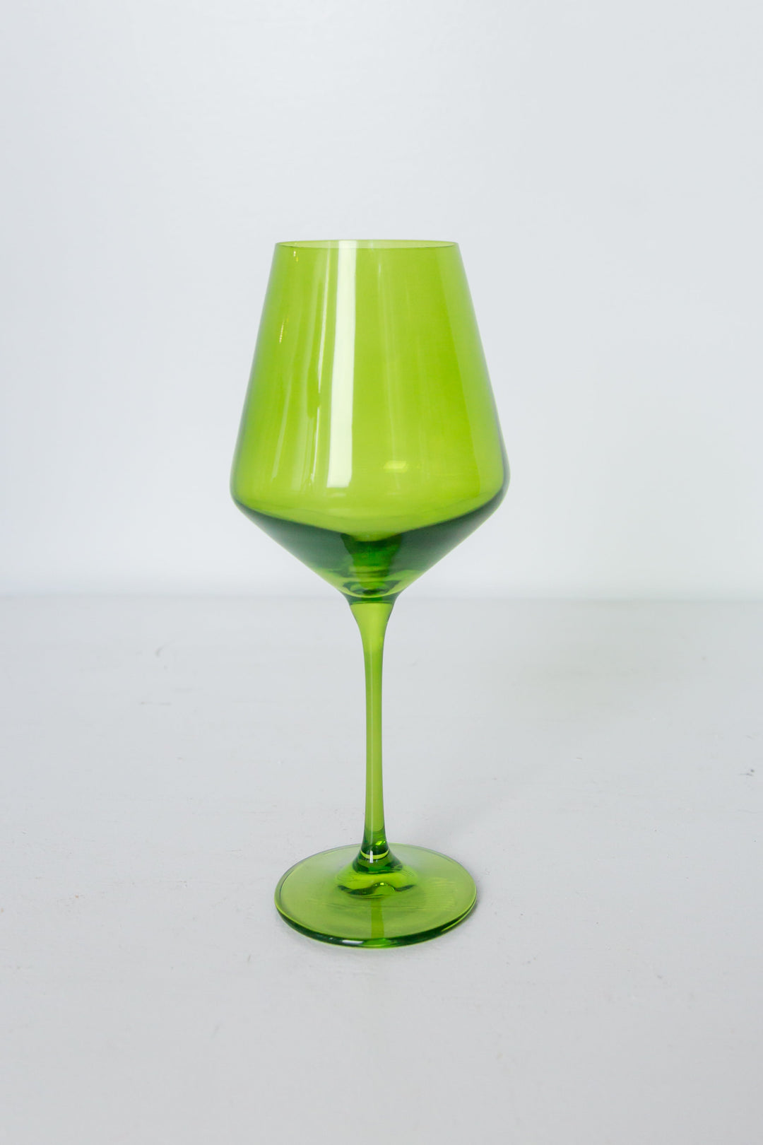 Green wine glass on a white background