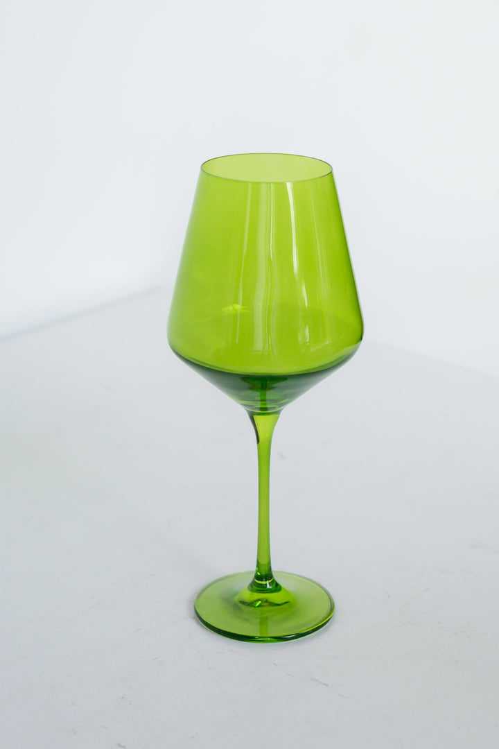 Green wine glass on a white background