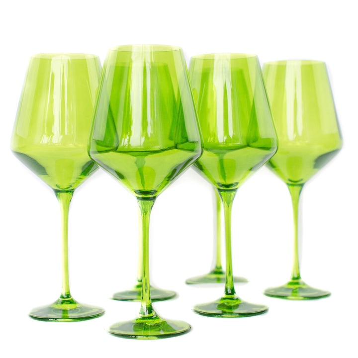 Five green wine glasses on a white background