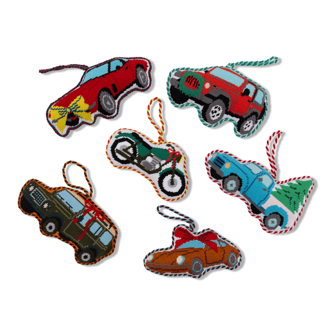 Group of Furbish vehicle needlepoint ornaments with the green motorcycle among cars and trucks