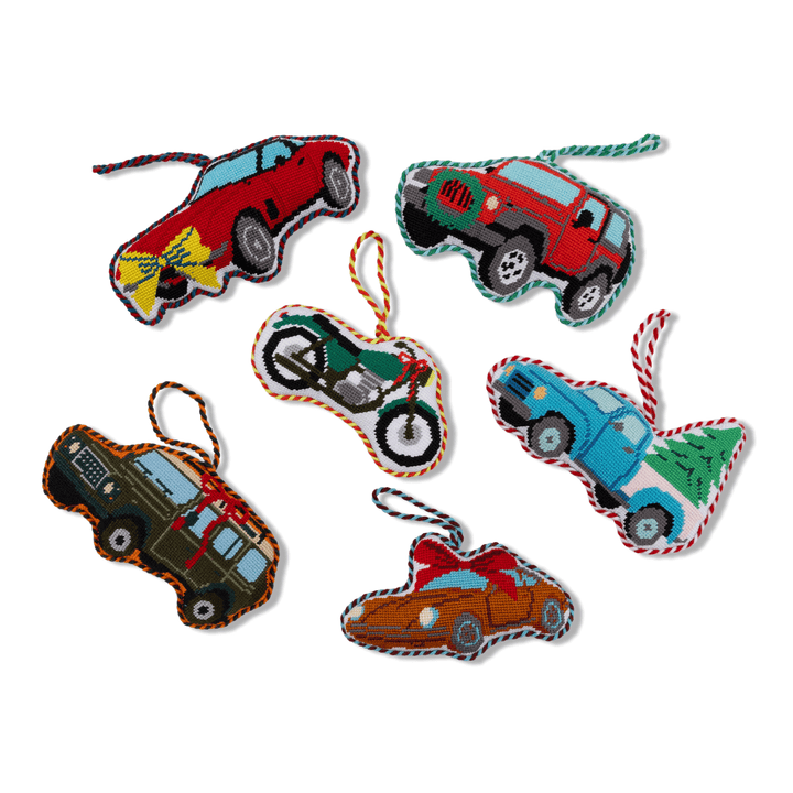 Group of Furbish vehicle needlepoint ornaments with the green motorcycle among cars and trucks