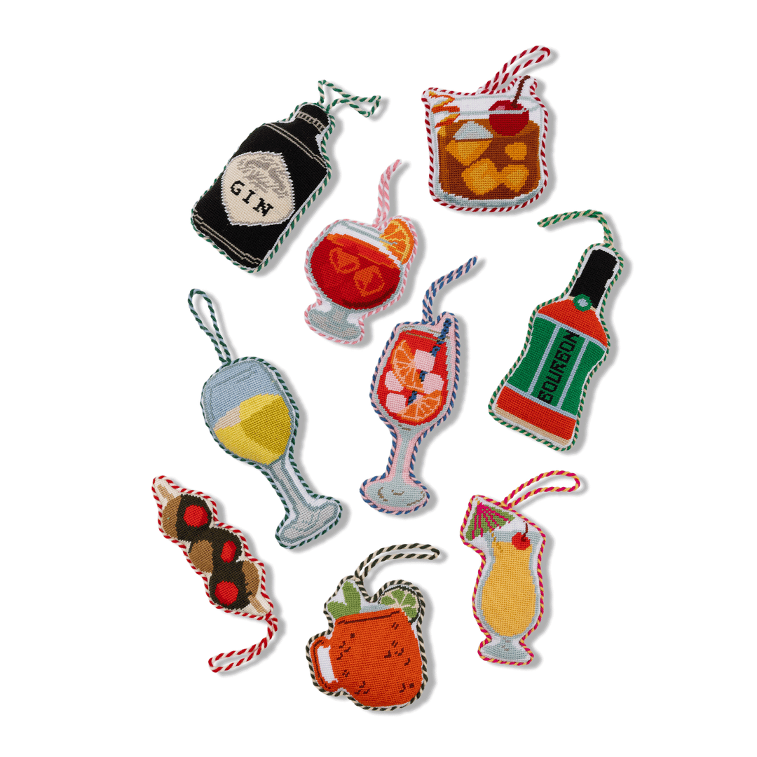 Group of Furbish cocktail and drink needlepoint ornaments with the white wine glass among them