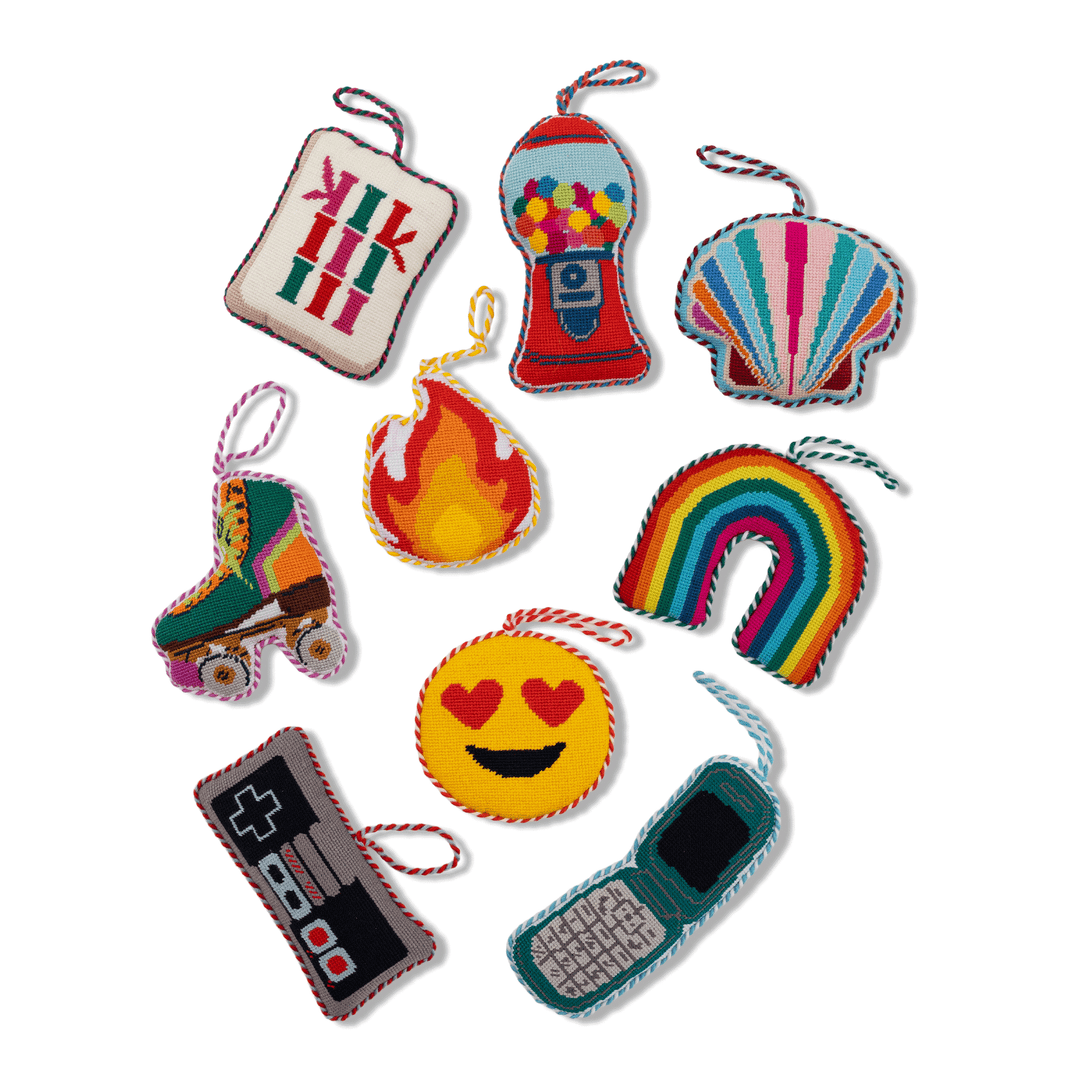 Group of Furbish needlepoint ornaments including the green roller skate, gumball machine, and flip phone