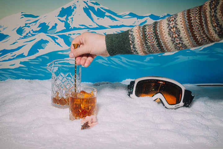Cozy fireside bourbon cocktail made with holiday mixer cubes