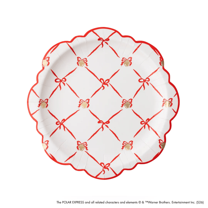 A white paper plate with a scalloped edge, decorated with a red lattice pattern of bows and thin red lines, and small gold gift boxes. The plate is photographed from directly above on a white background.