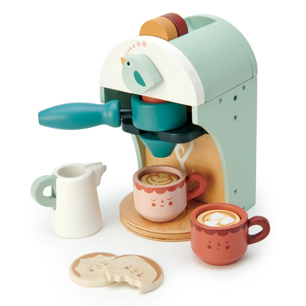 Angled studio view of the toy coffee maker with a latte cup under the spout and play biscuits