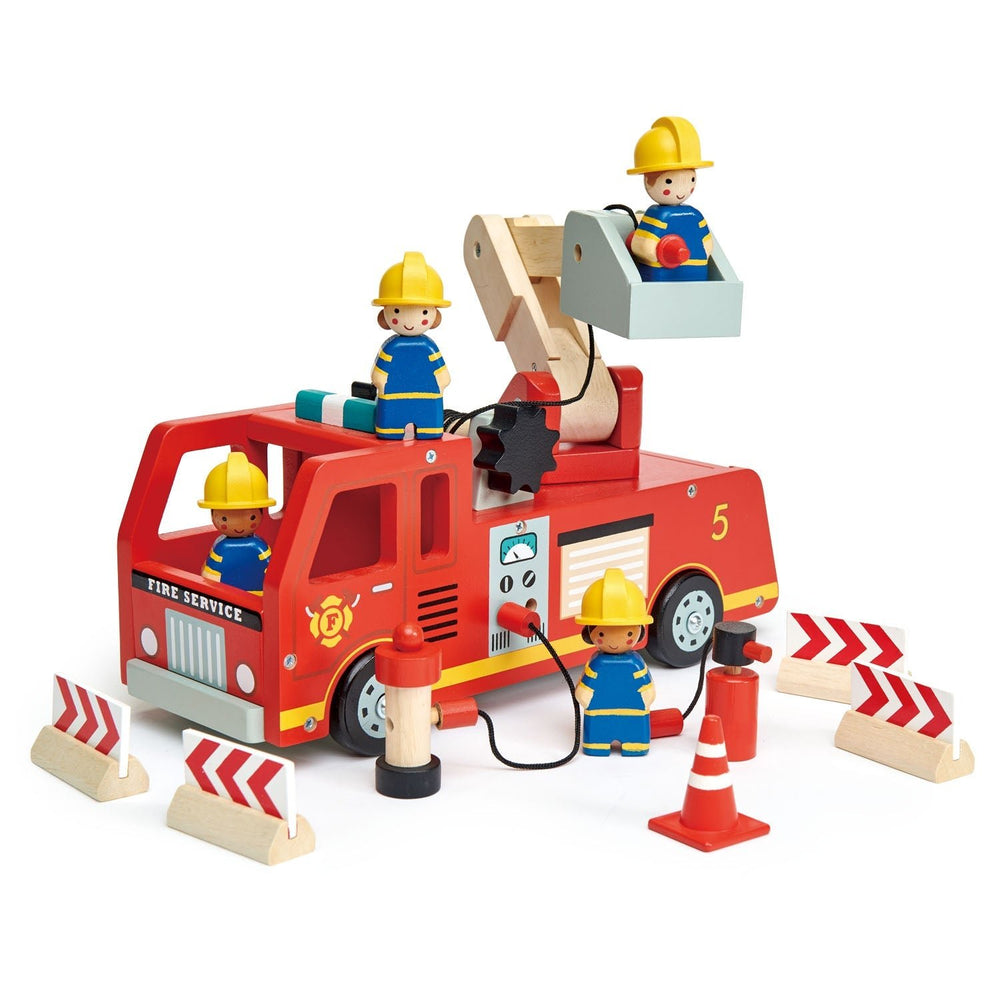 Front view of the wooden fire engine with a firefighter in the ladder basket and chevron barricades around it