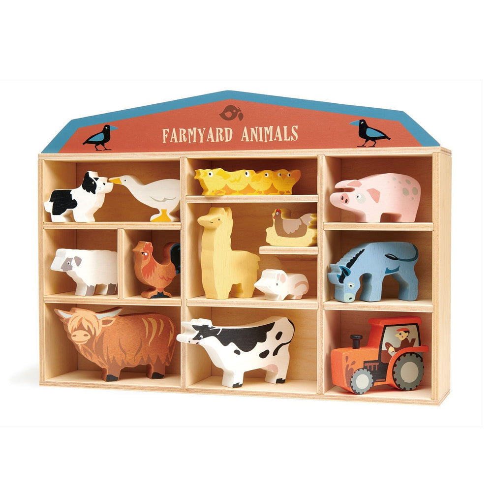 Angled view of the farmyard barn display shelf with wooden cows, pigs, sheep, and hens
