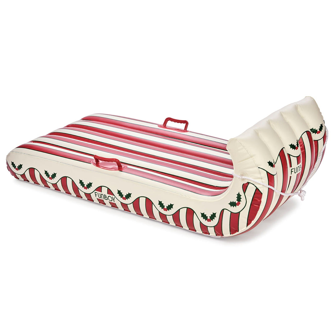 Red and cream striped inflatable toboggan sled with a holly leaf border on white