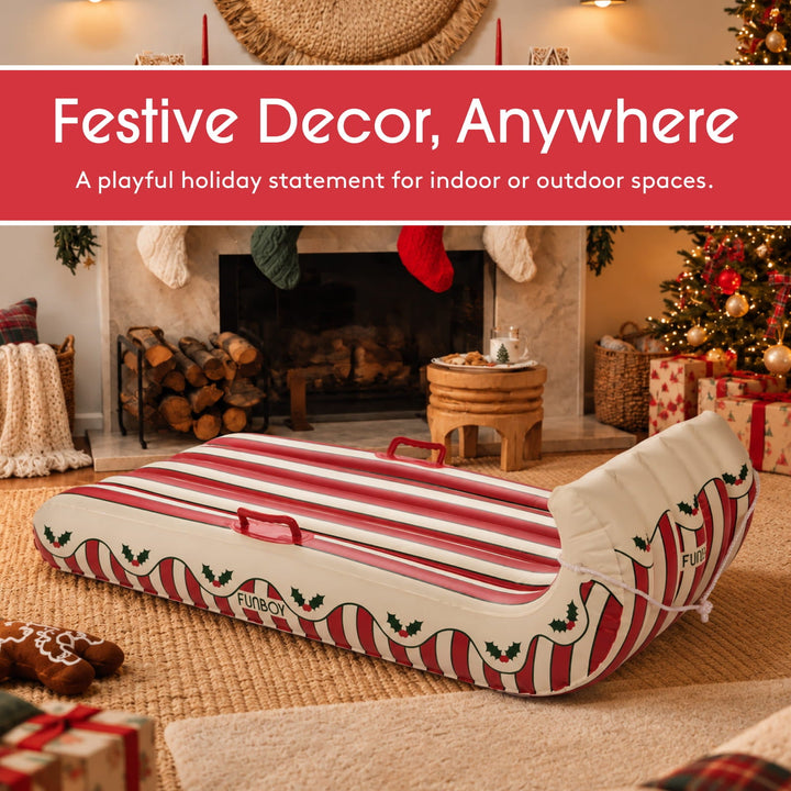 Holly stripe inflatable toboggan as holiday decor in front of a fireplace
