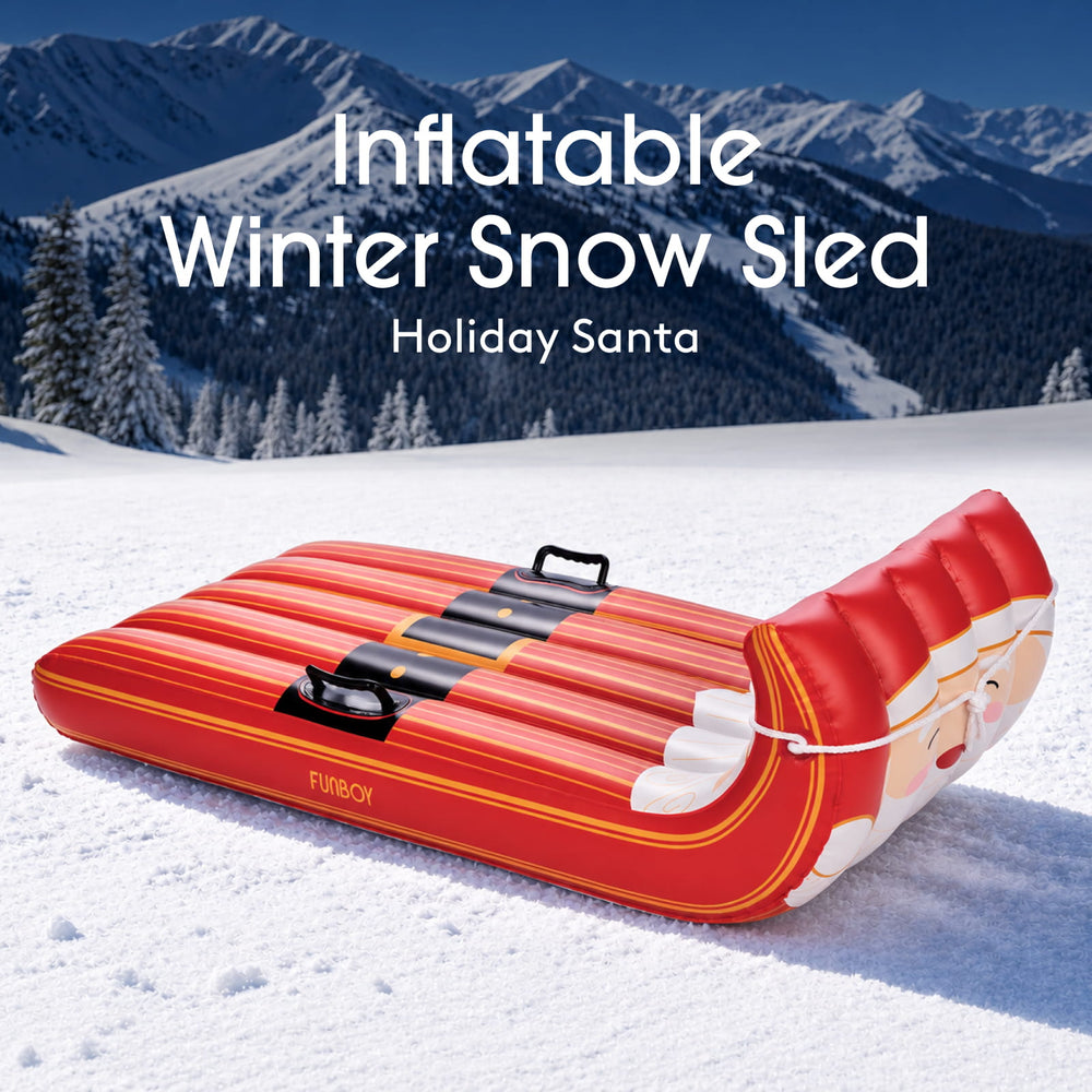 Santa inflatable Christmas toboggan sled on a snowy hillside under a winter sky