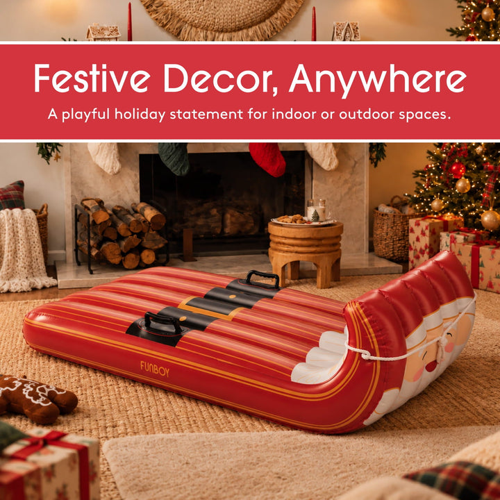 Santa inflatable toboggan sled used as holiday decor in front of a fireplace with stockings