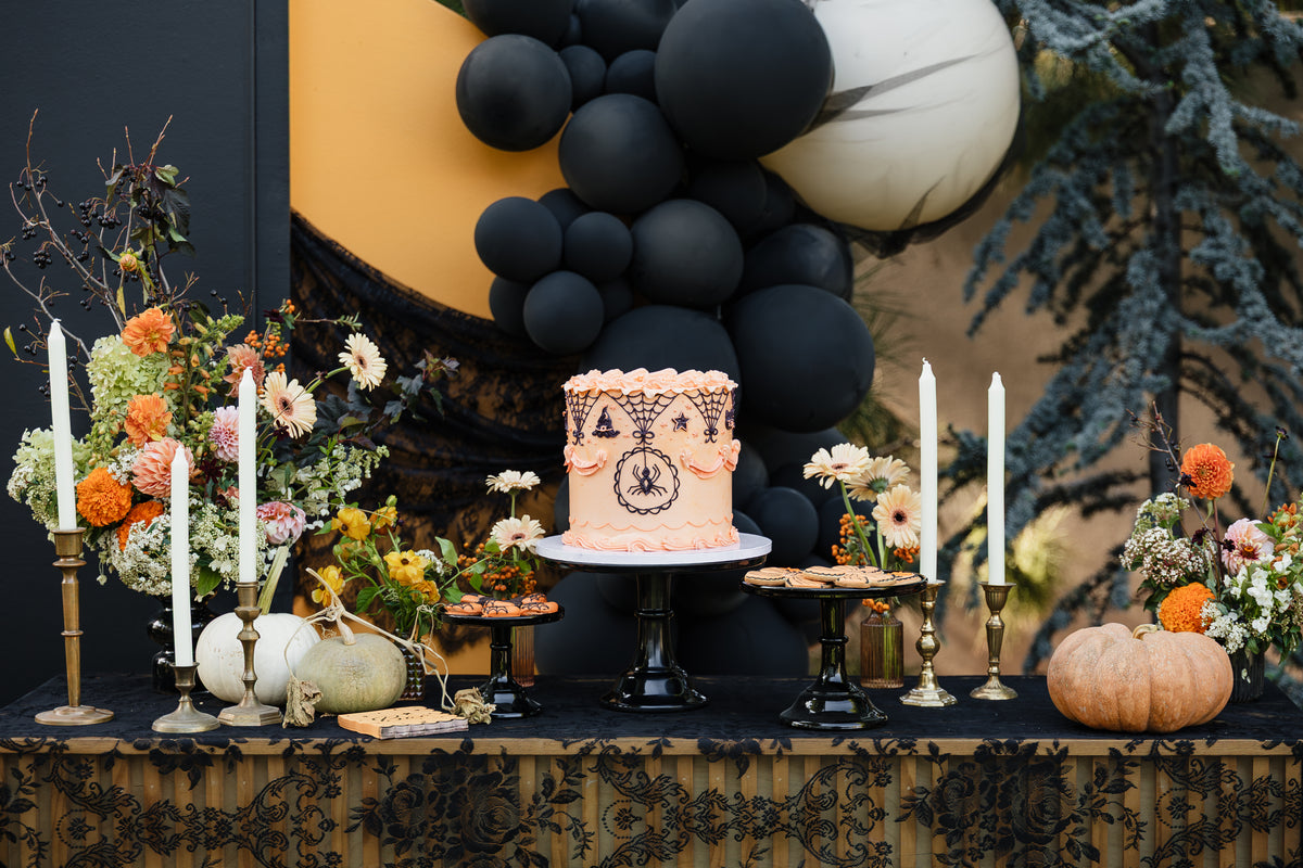 vintage halloween cake and cookies on a vintage halloween dessert table.