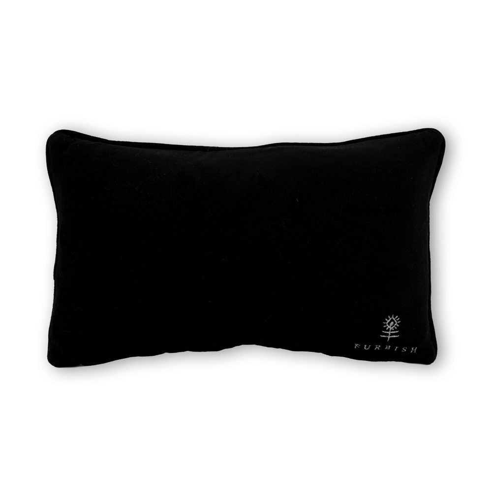 Black velvet back of the Too Ghoul for School needlepoint pillow with an embroidered flower logo