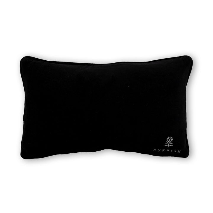 Black velvet back of the Too Ghoul for School needlepoint pillow with an embroidered flower logo