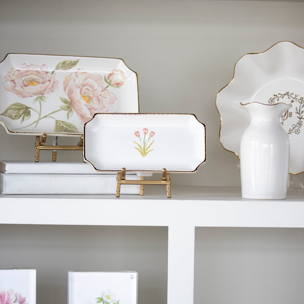 Tulip valet tray propped on a white shelf beside floral dishes and a vase, a pretty hostess gift