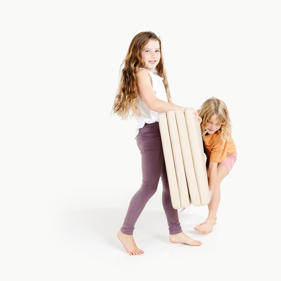 Gathre tumbling mat styled in a modern neutral kids' space.